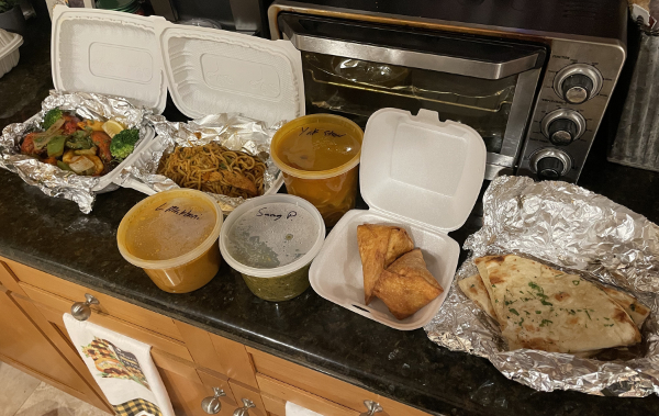 A large amount of take-out food from
Tara's, including naan, vegetables, a couple of stews, some noodles, and some sort of turnovers.