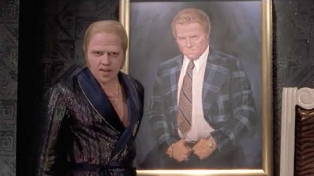 Biff Tannen, as he appeared
in 'Back to the Future, Part II,' standing in front of a mural of himself.