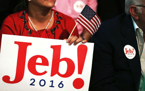 Bush supporters hold a Jeb! sign and wear a 
Jeb! sticker.