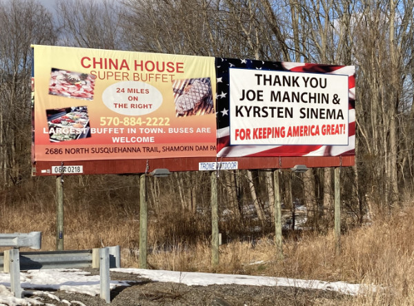 A billboard in Pennsylvania,
with an American flag pattern in the background, reads 'Thank you Joe Manchin and Kyrsten Sinema for keeping America great.