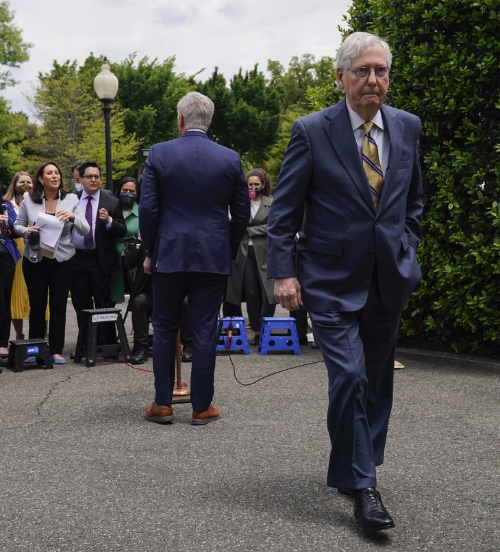 Kevin McCarthy addresses reporters, while McConnell is
walking away with a nasty scowl on his face
