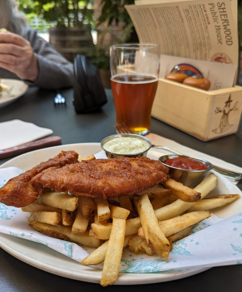 Fish and chips, a menu, and a glass of beer