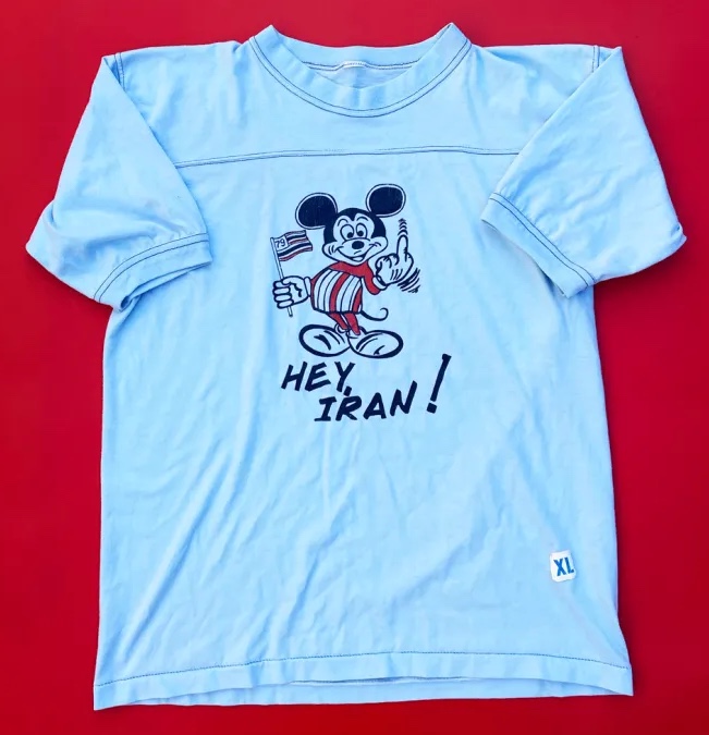 Mickey Mouse makes an obscene gesture,
accompanied by the phrase 'Hey, Iran'