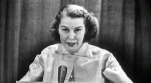 Martha Rountree, sitting with a microphone in front of her