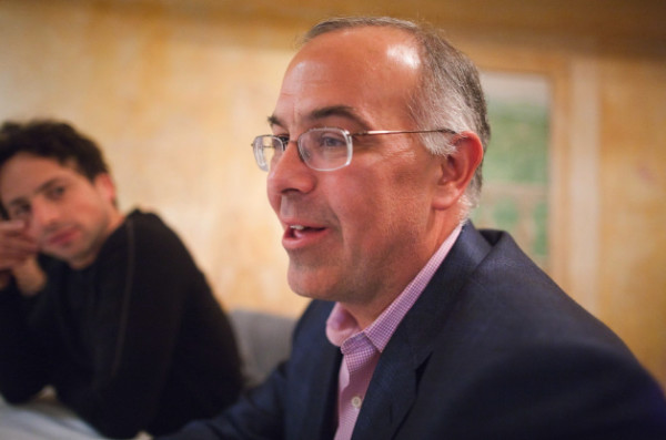 David Brooks at a table with someone;
Epstein is not in the photo, but the image WAS in the Epstein collection