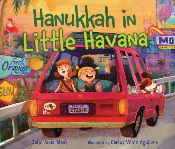 The book
shows a child-book-style drawing of a family in a small station wagon. The title is 'Hanukkah in Little Havana.'