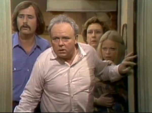 The show's four
protagonists stand in the doorway to their house with shocked looks on their faces