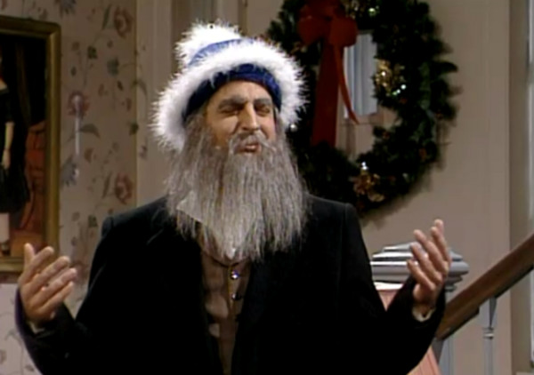 A man with a rabbinic
beard and a blue-and-white Santa Claus-style hat.