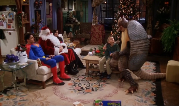 Superman and Santa Claus sit on a couch watching, while a man
in an armadillo costume holds an elementary-school-aged boy on his lap