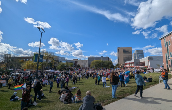 A large crowd in a
public square; American and gay pride flags are visible