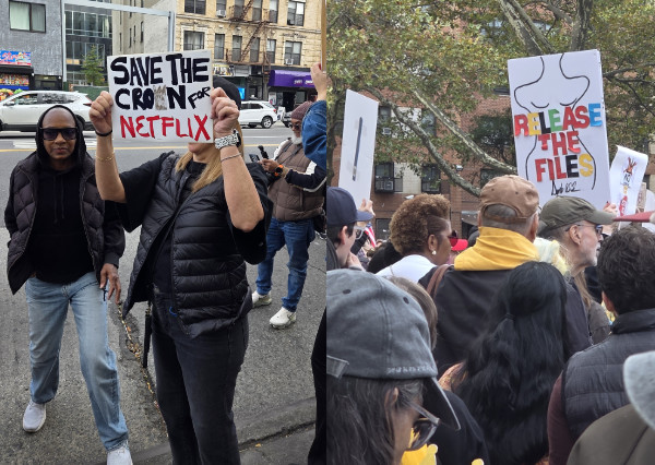 One person holds a sign
that says 'Save the Crown for NETFLIX' and a different person holds a sign with the outline drawing that Donald Trump
did for Jeffrey Epstein and that says 'Release the Files!'