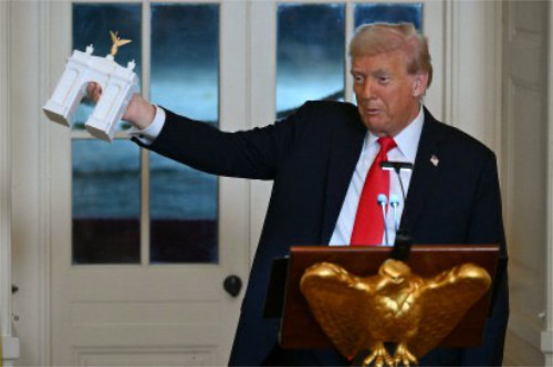 Trump waves the model of his arch around