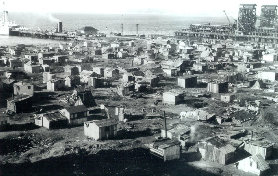 Hooverville with hundreds of temporary shacks made from plywood, cardboard, and aluminum siding