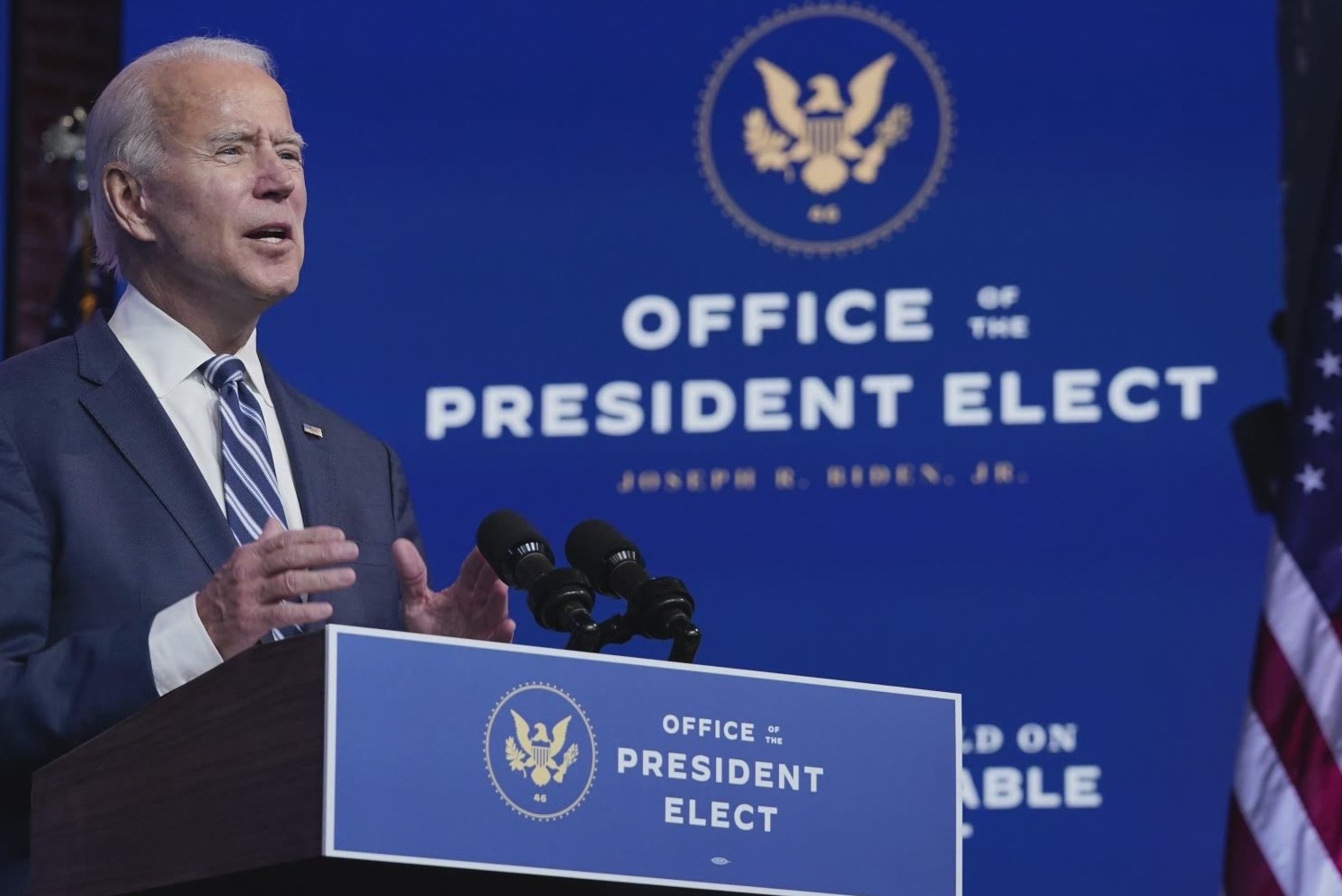 Joe Biden stands at a podium that has a fancy-looking
seal with an eagle and the text 'office of the president elect'