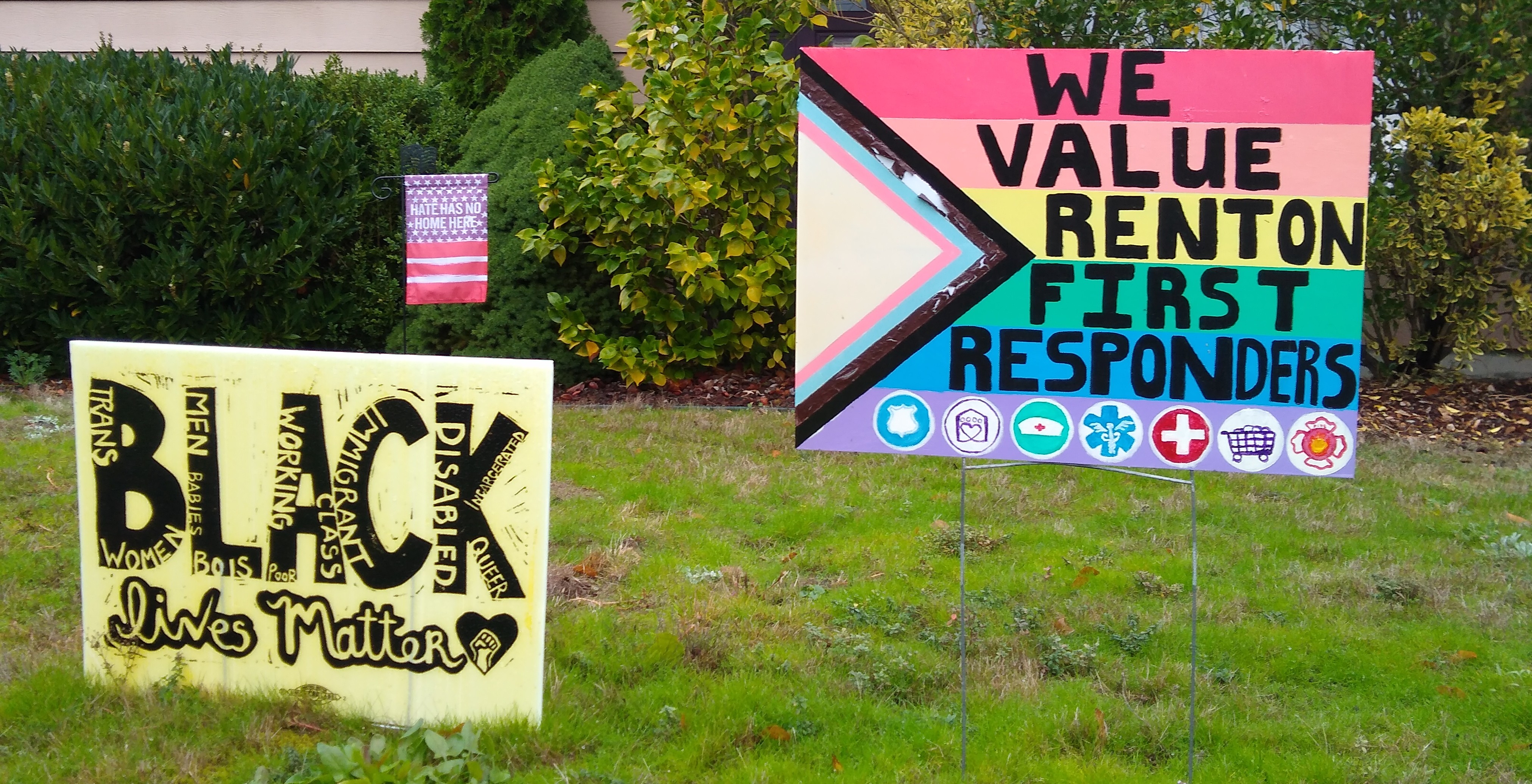 One sign supports Black
Lives Matter, the other is rainbow-colored and thanks first responders