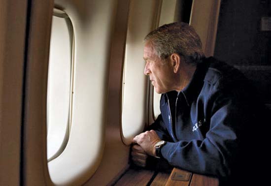 Bush the son looks out the window of Air Force One at the devastation wrought by Hurricane Katrina