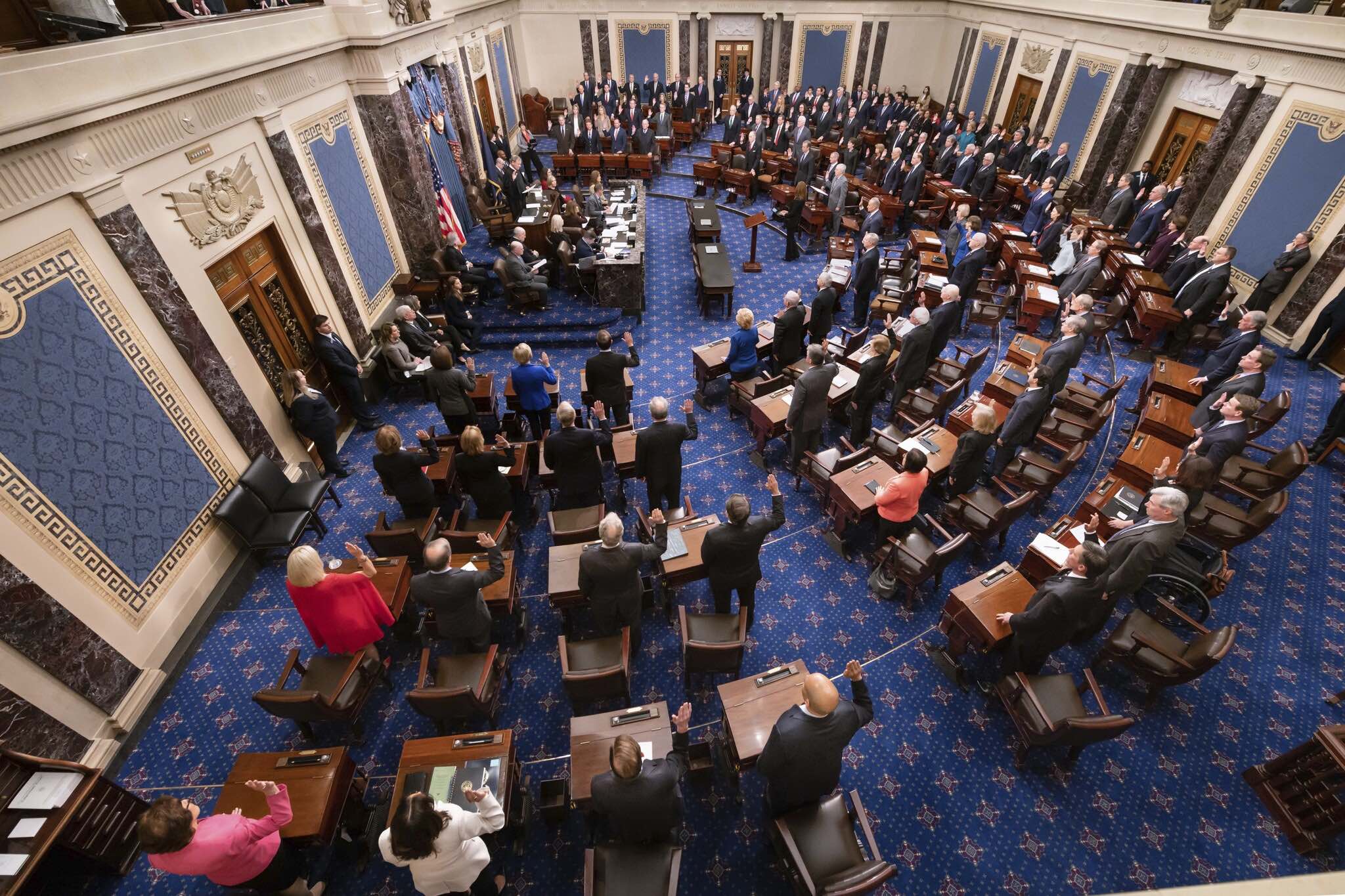 All 100 Senators are standing
at their desks, with their right hands raised.