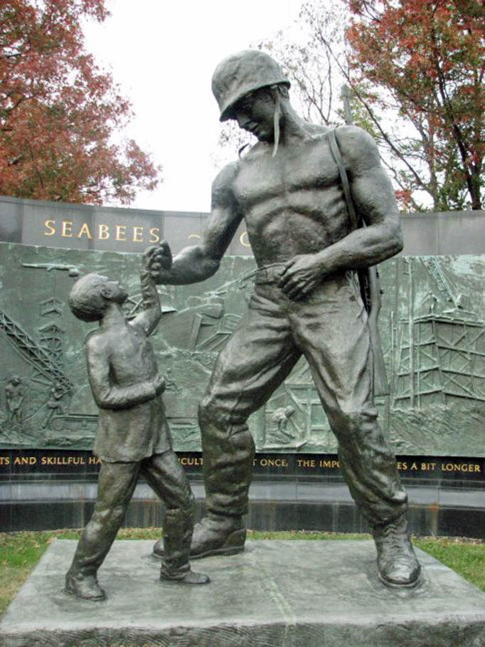 A muscular, shirtless sailor dances with a child