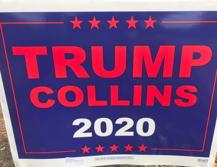 A Trump/Collins 2020 sign, and
at the very bottom it notes that it's paid for by the Democratic Party of Maine