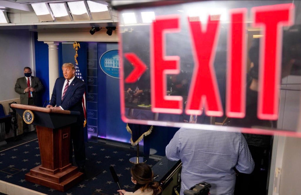 The photo is framed such
that an exit sign in the White House appears to be instructing Trump to leave