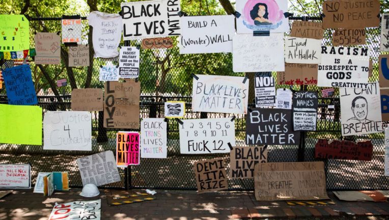 The fence is absolutely blanketed in handmade posters
about George Floyd and Black Lives Matter