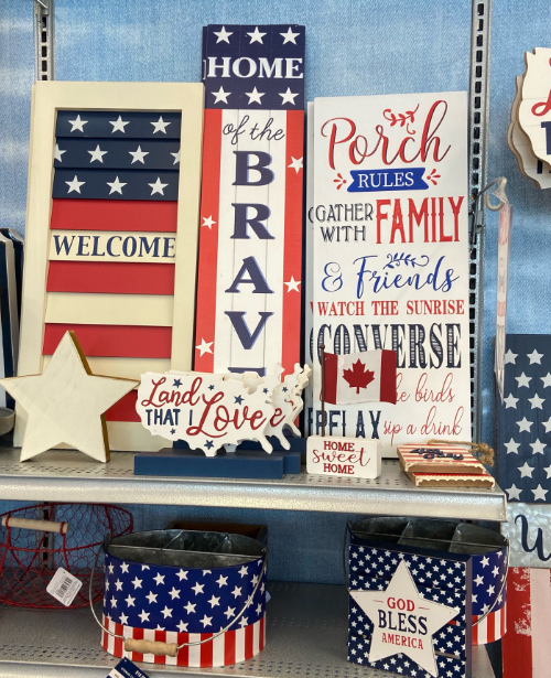 Among a display of wooden,
patriotic wall-hangings with flags and patriotic sayings, there is also a small Canadian flag for sale.