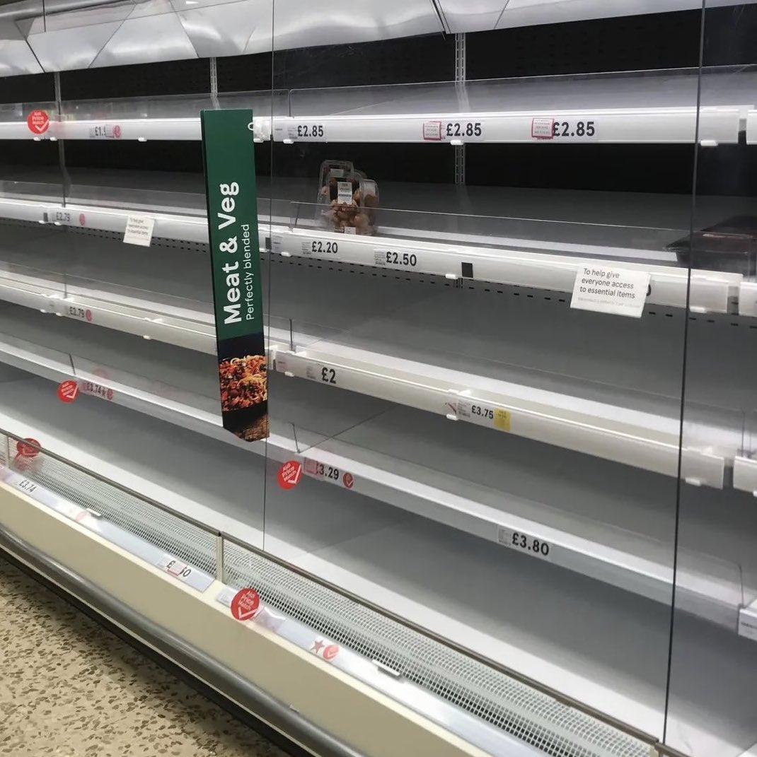 A bunch of empty shelves, with 
prices listed in pounds sterling