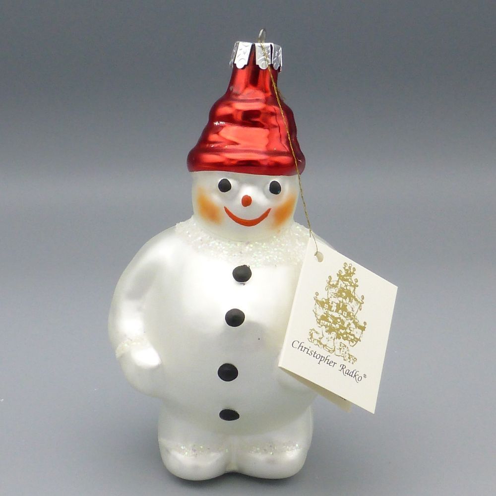 Frosty the Snowman in white ceramic with 
a red Santa-style hat