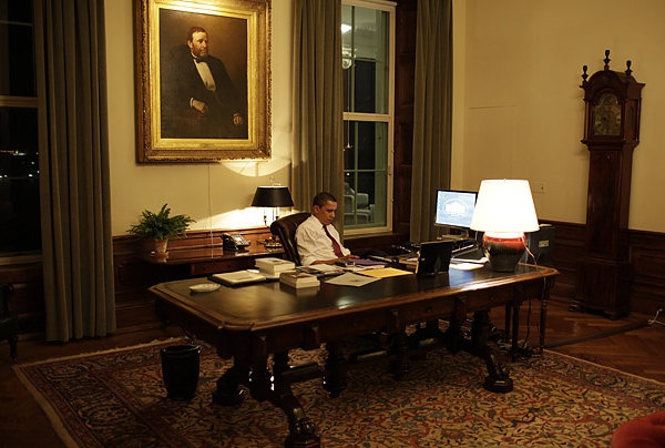 The room is quite large, the desk is huge, and there is a picture of U.S. Grant hanging above the chair where Obama is sitting