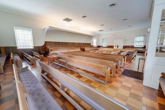 A Quaker meeting room,
and what appear to be small offices segregated from the main, pew-filled area