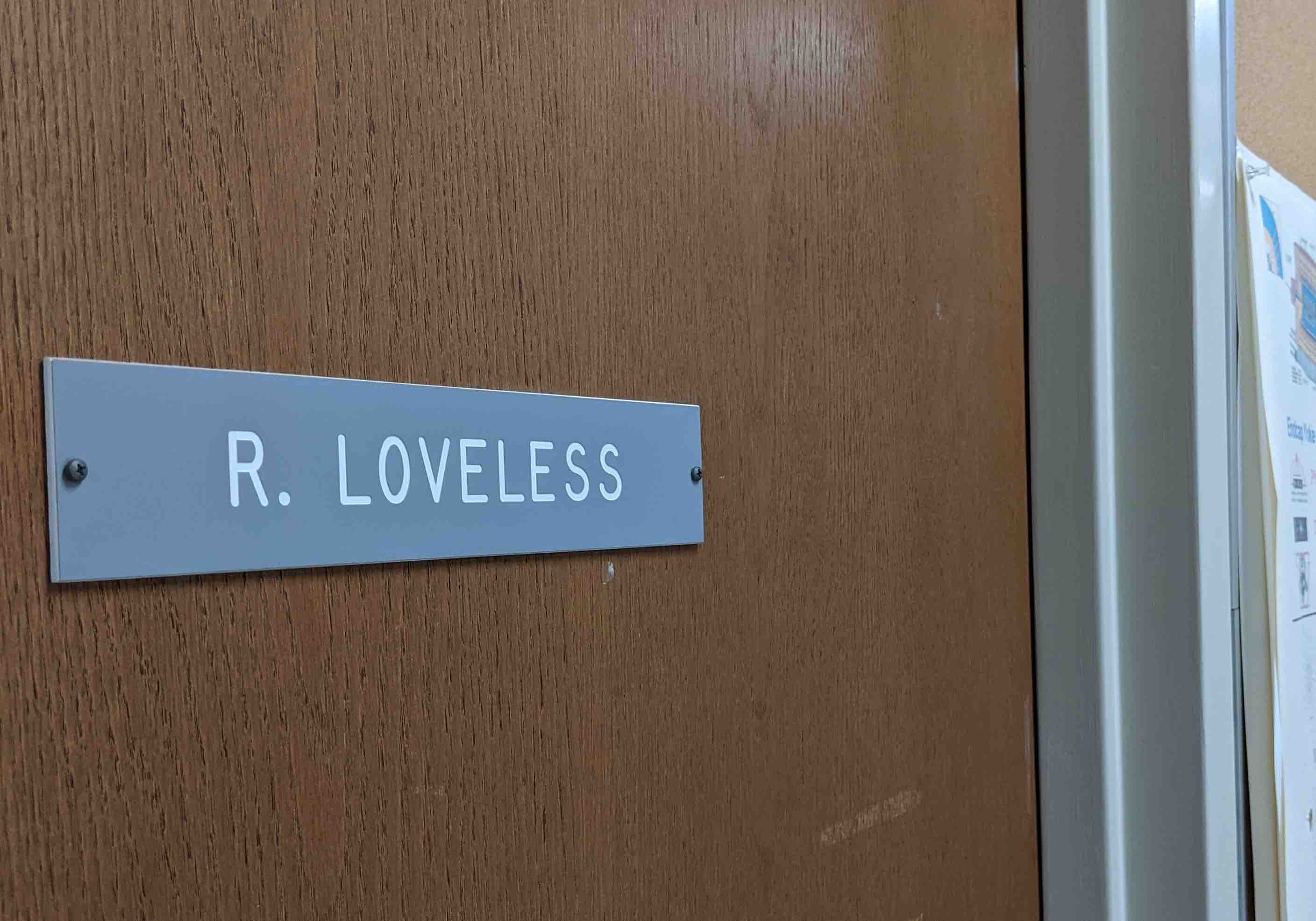The nameplate on a door reads 'R. Loveless'