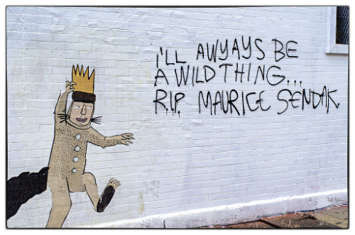 Street art where someone has painted a wild things
character along with the message 'I'll always be a wild thing, RIP Maurice Sendak