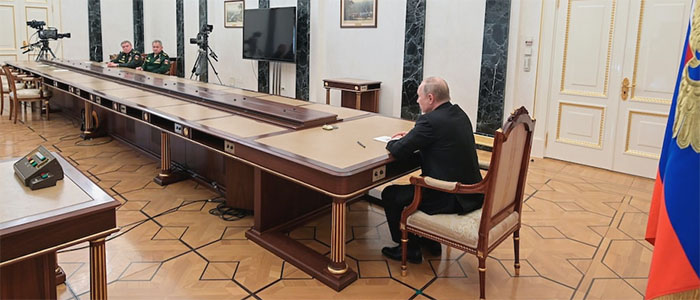 Putin sitting at a very long table, with a camera
about 25 feet away, and then two military officers, and then another camera about 50 feet away.