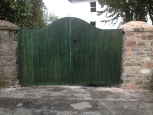 A green-colored pair of gates