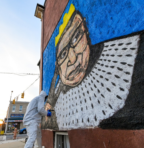 A mural of Ruth Bader Ginsburg in which she
is wearing a crown and looks more like Thurgood Marshall than she does herself