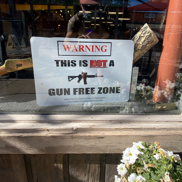 Front window of Shooter's Grill,
with its logo, which is the name of the establishment in a Wild West font, and two Colt revolvers