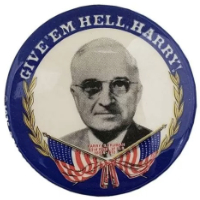 A pin says 'Give 'em Hell, Harry' and has a picture of Harry S. Truman