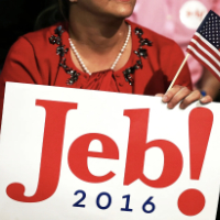 A woman holds a 'Jeb!' placard