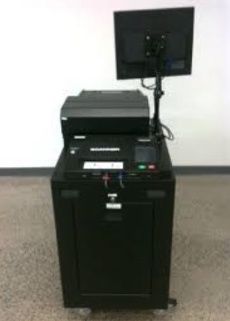 The machine looks like a black
cabinet with a printer on top and a monitor mounted on an arm on the corner