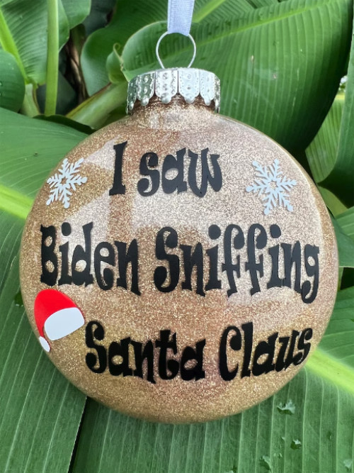 A Christmas ornament that says 'I saw Biden sniffing Santa Claus'
