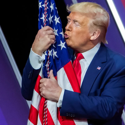 Trump hugs/kisses the American flag