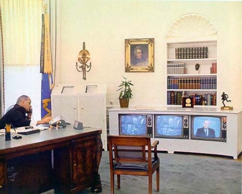 Three identical TVs, installed
in a custom cabinet, tuned to three different channels