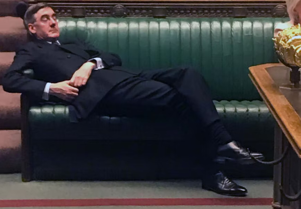 Rees-Mogg is occupying an entire bench by himself
and appears to be sleeping