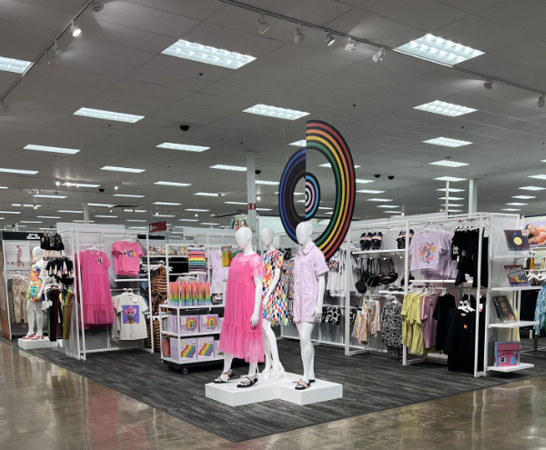 A display of Pride merchandise, framed by
a mirror-shiny waxed cement floor