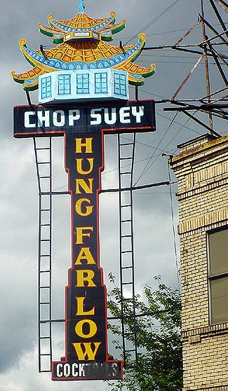 The restaurant is called 'Hung Far Low Cocktails, and someone has blacked out the tails portion of the sign'
