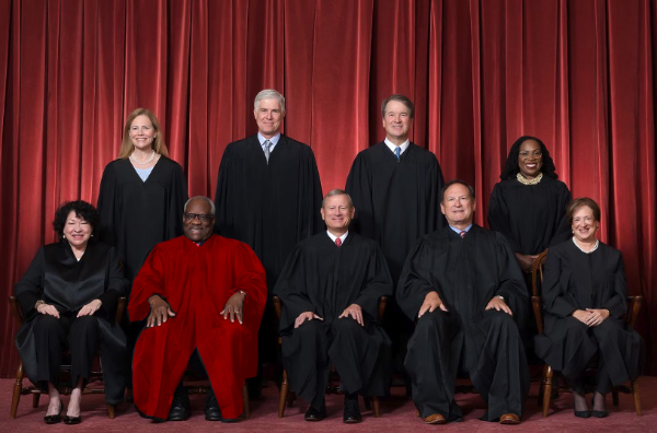 The Supreme Court's annual photo,
but with Clarence Thomas' robes colored scarlet