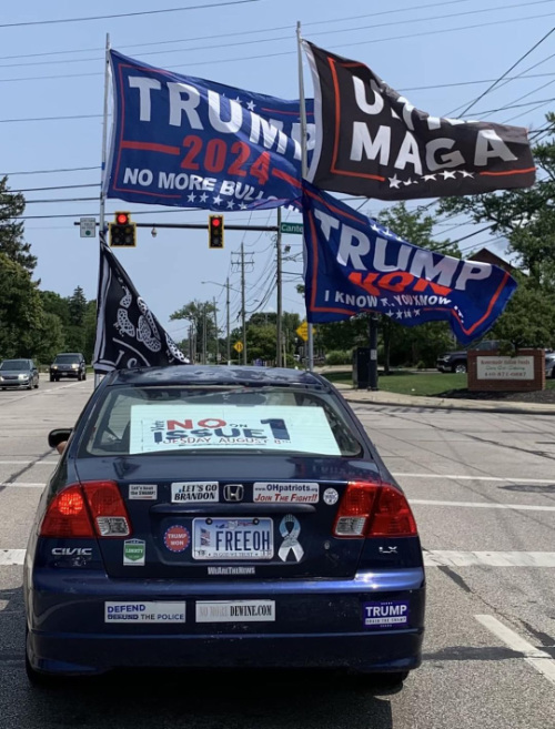 A car festooned with Trumpy bumper
stickers and flags, but also a sign that says 'No on 1'