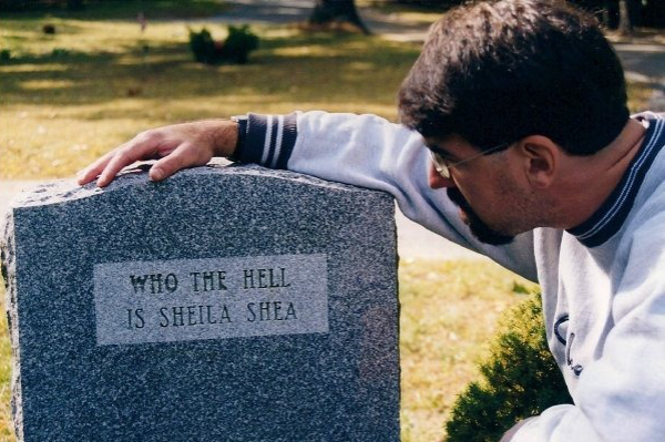 A tombstone reads: 'Who the hell is Shiela Shea?'