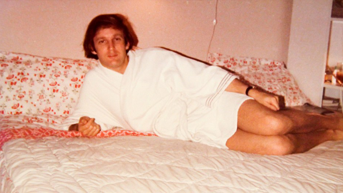 A 1980s picture of Trump in a bathrobe, posing on a bed