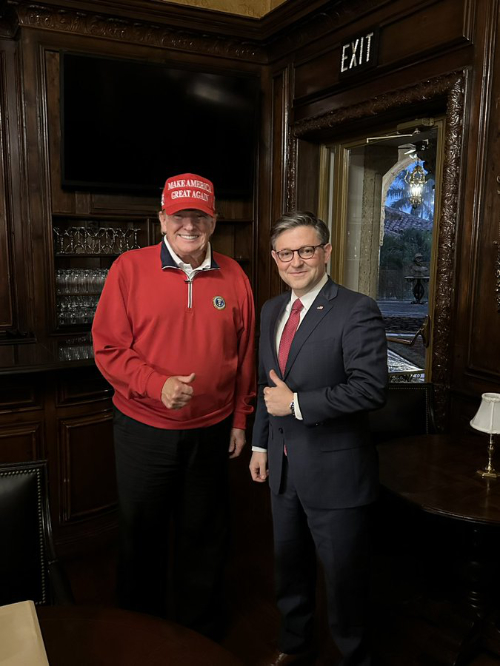 Donald Trump and Mike Johnson pose, thumbs-up, at Mar-a-Lago